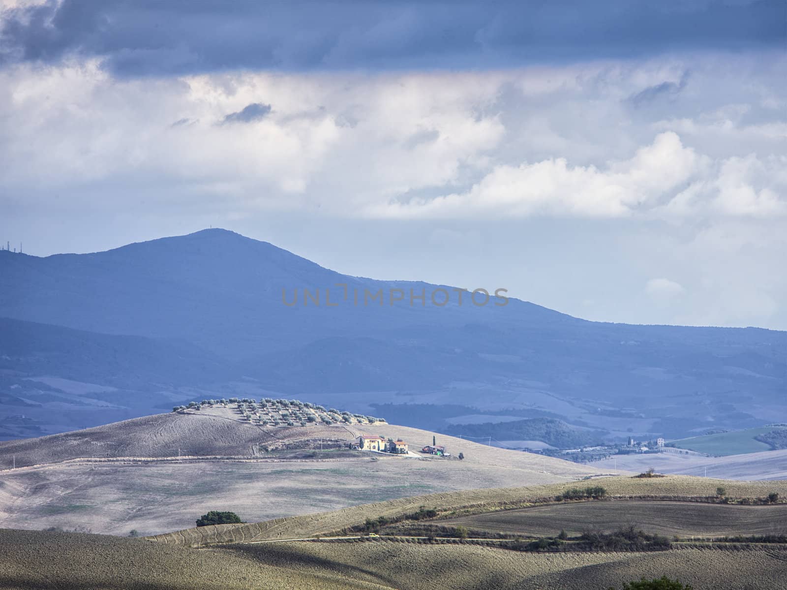 tuscan mountain range and field