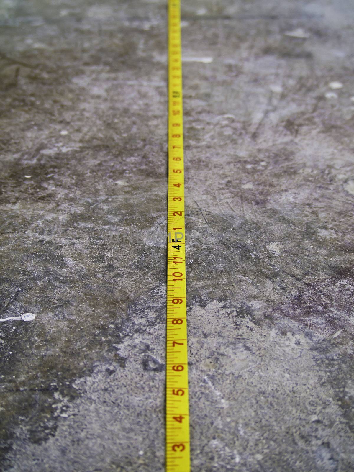 Measuring Tape on Concrete Floo by siraanamwong