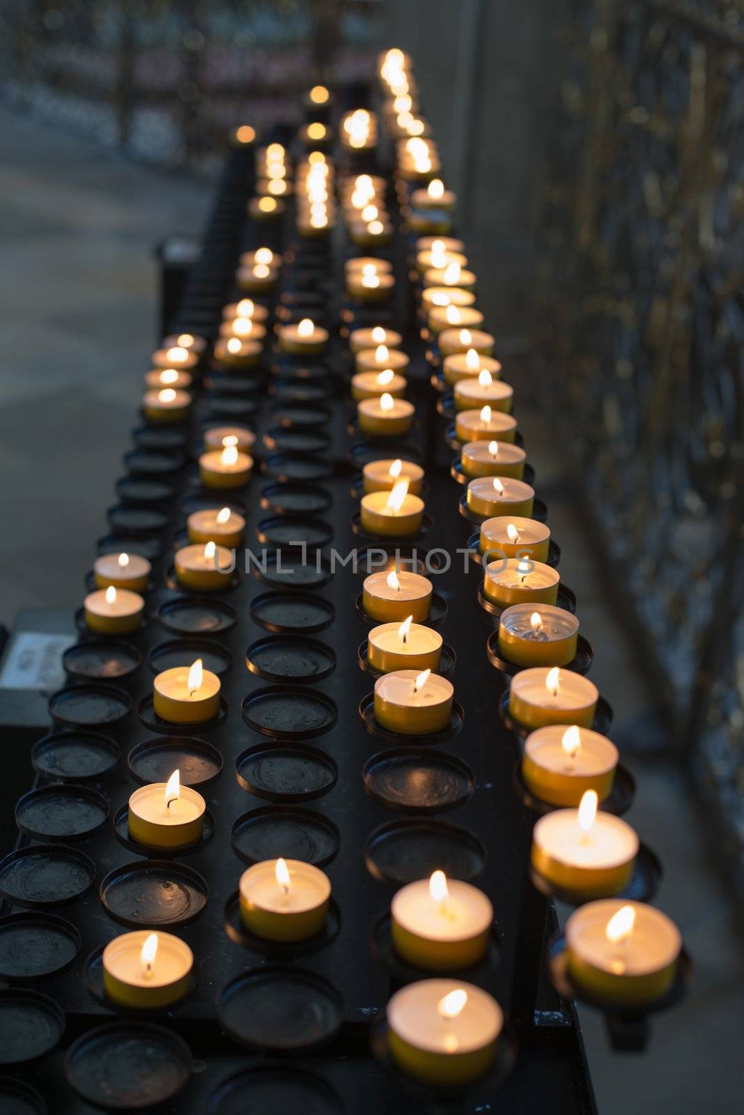 Prayer candles aka offering, sacrificial or memorial candles lit in a church