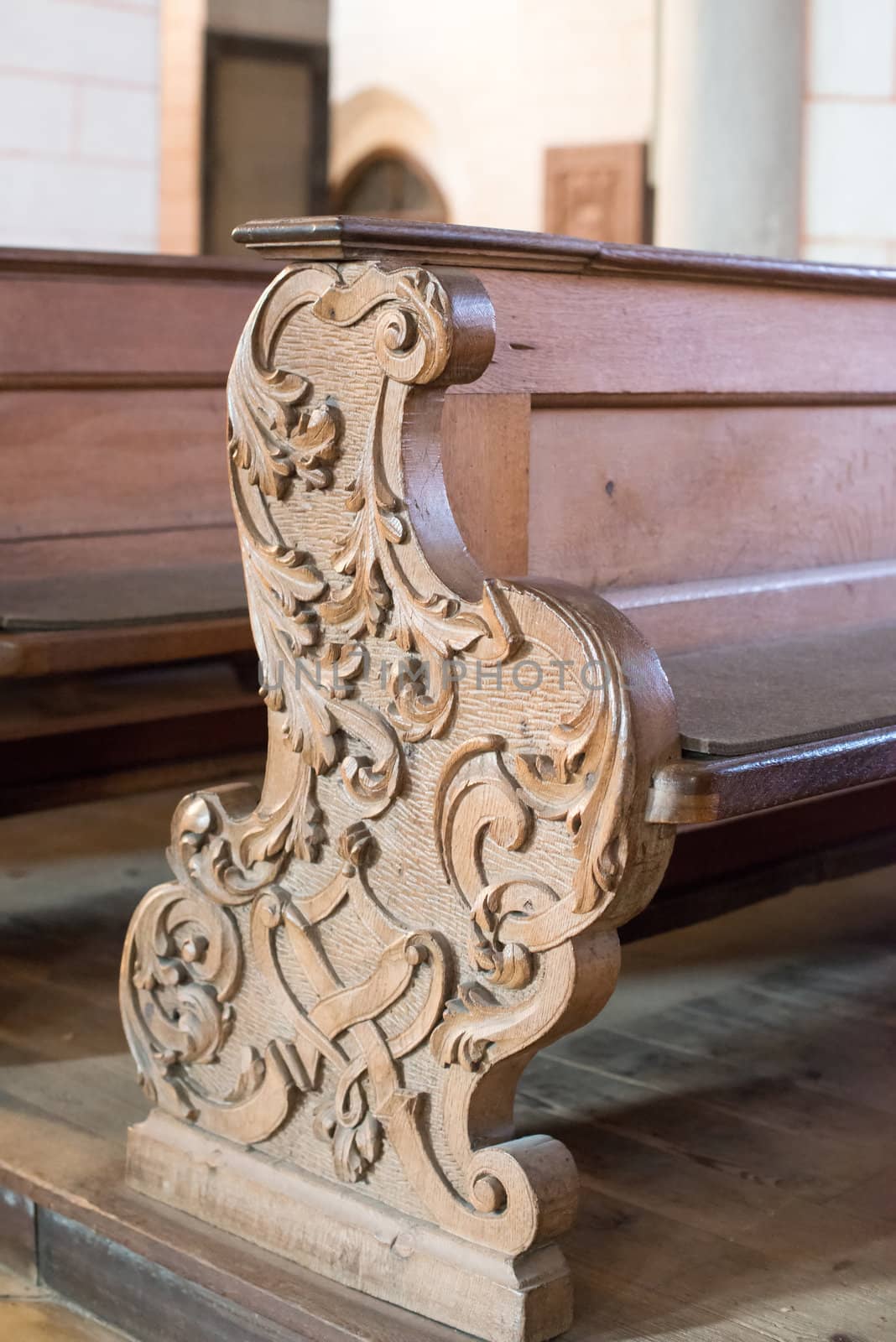 rows of beautifully decorated old wooden church benches