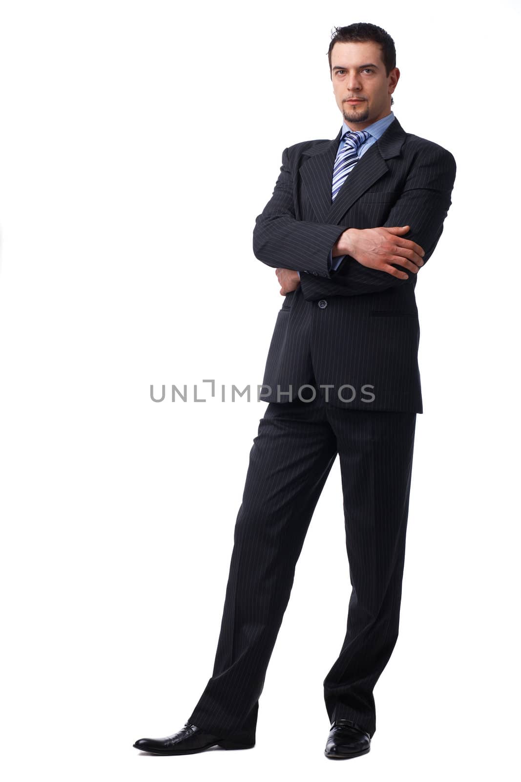 Confident Businessman Standing With Folded Hands. by romanshyshak