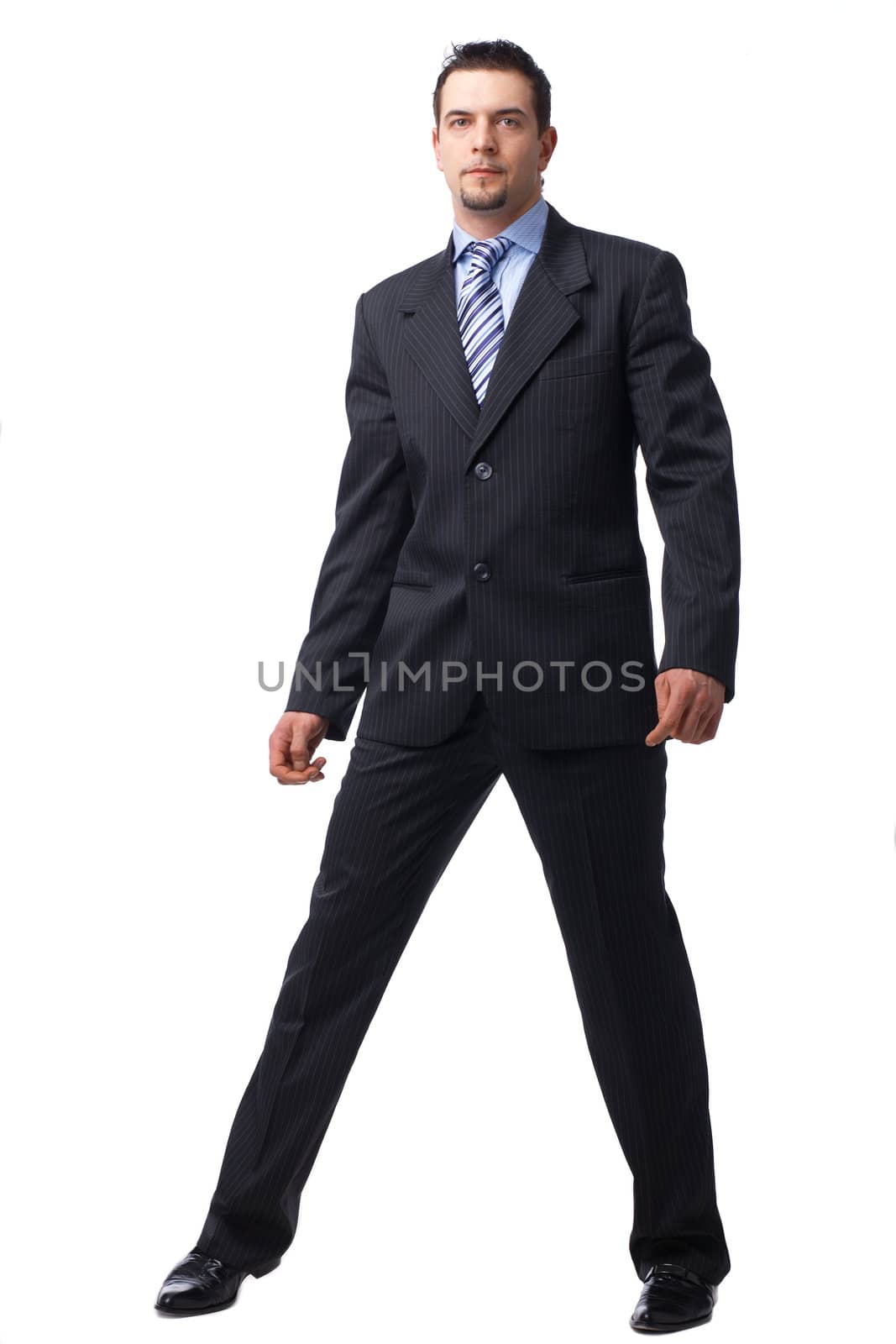 Portrait of a confident young businessman standing over white background.