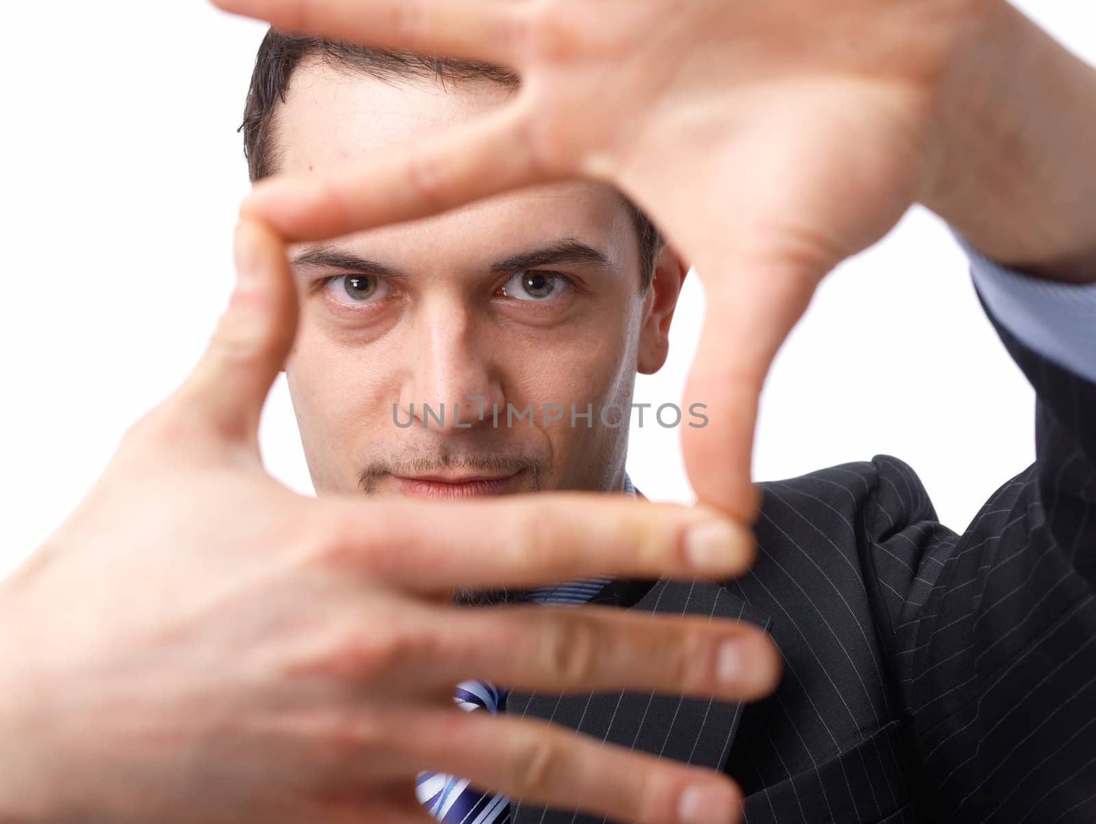Close up portrait of a confident young businessman making a frame shape with his hands over white background 
