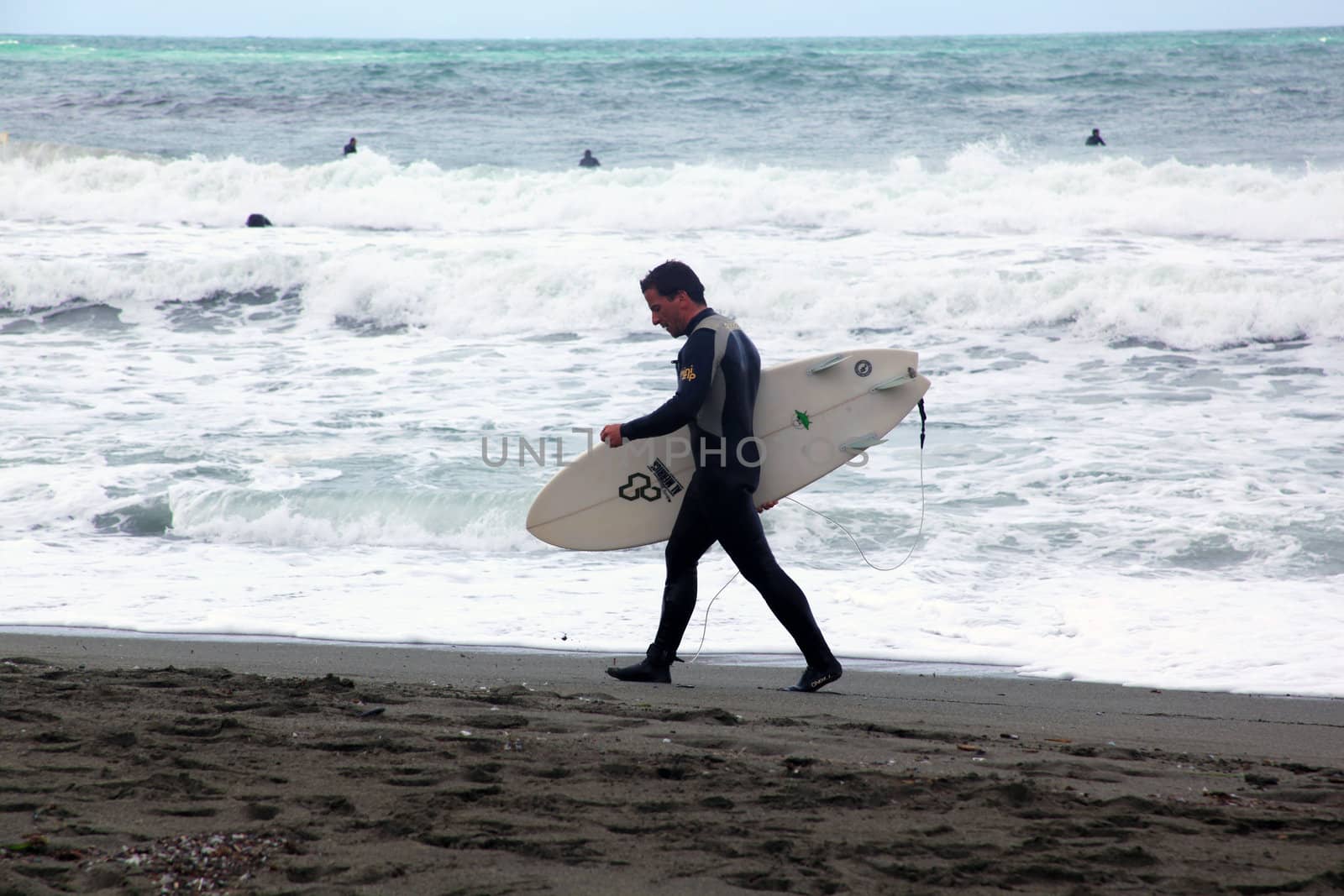 Surfer on the beach in Levanto, Italy