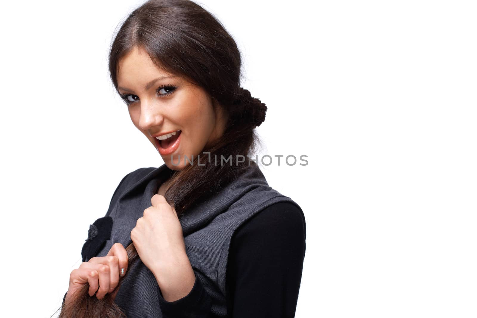 Portrait of a happy young girl playing with her hair over white.