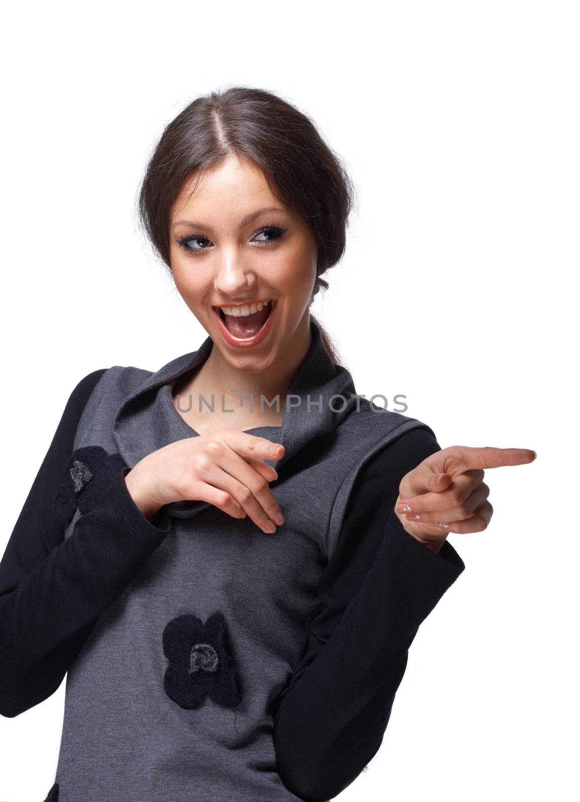 Portrait of a young happy girl pointing at you over white.