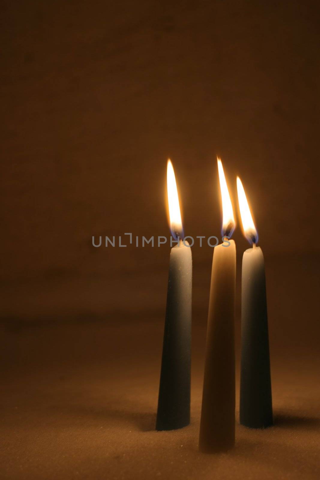 Closeup of burning candles outside in winter time