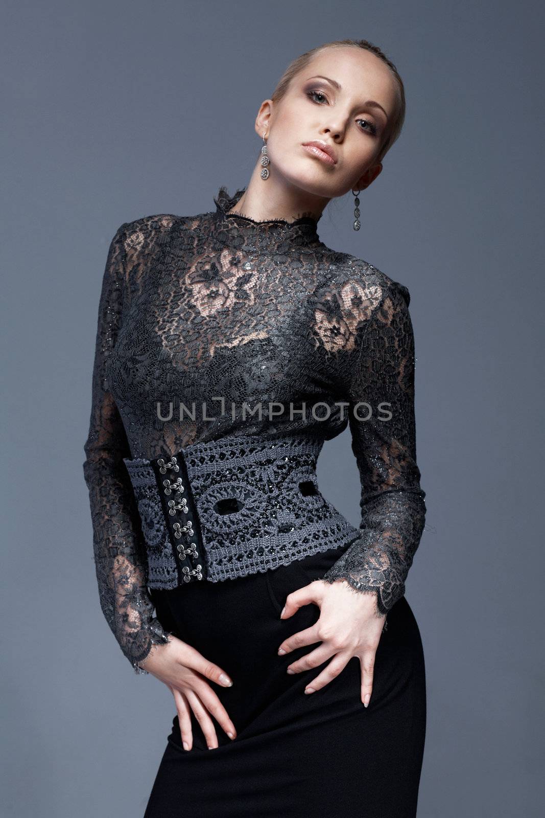 Portrait of a beautiful model in black, lace blouse, posing.