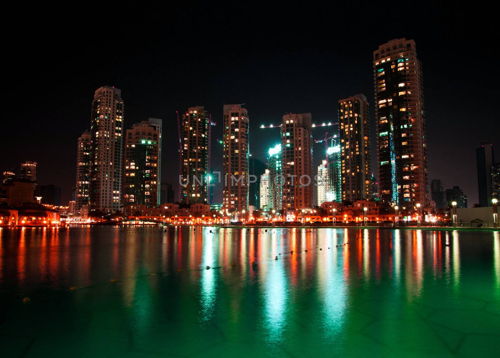 nice view of dubai city at night with reflections in water