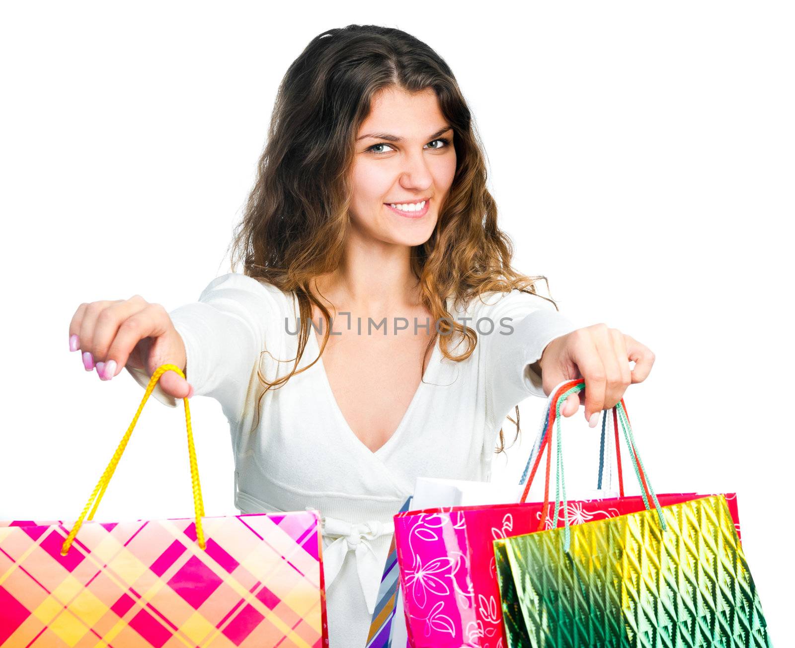 Smiling girl with colorful shopping bags isolated on white