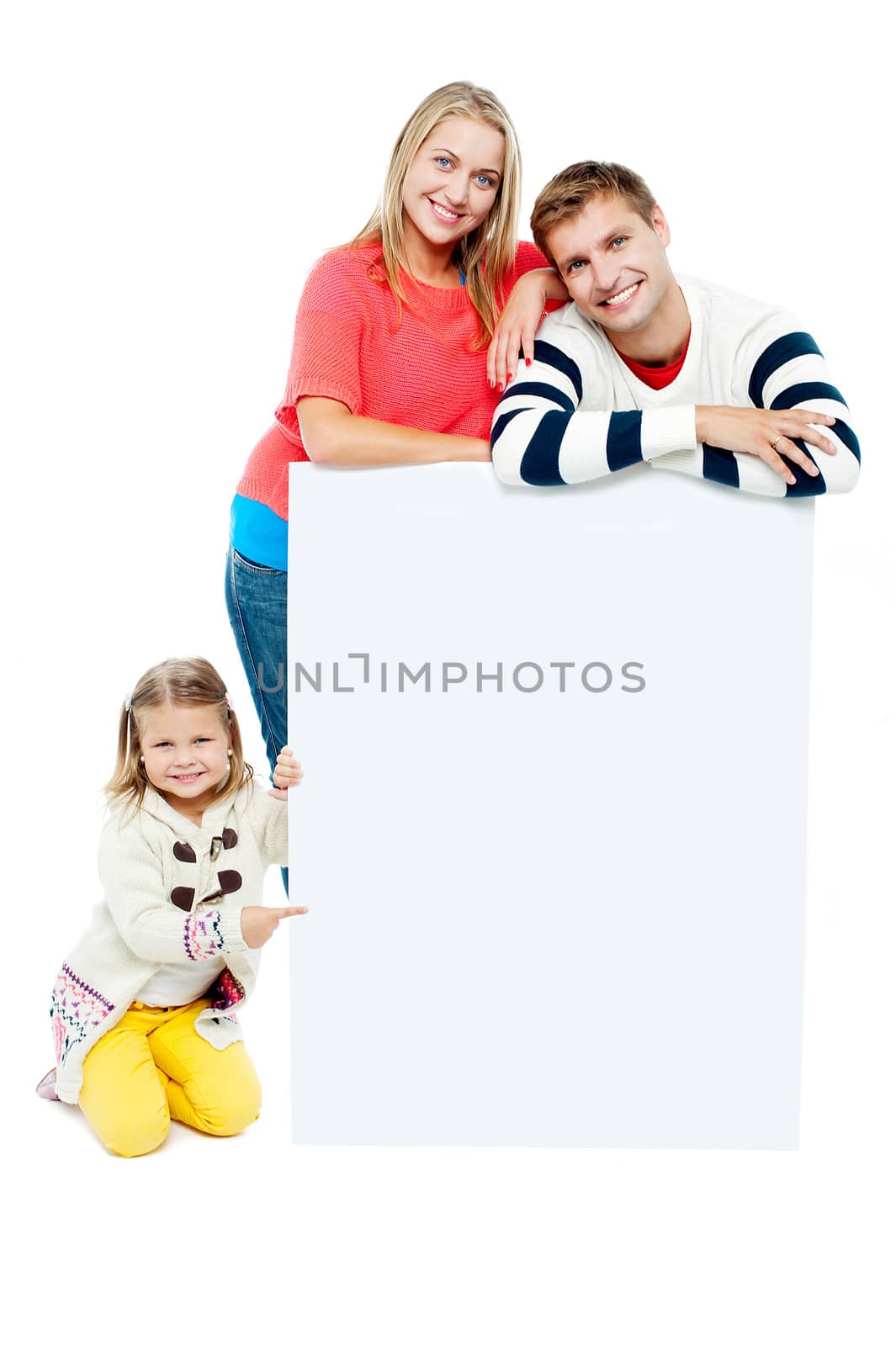 Portrait of happy family presenting blank whiteboard. Studio shot