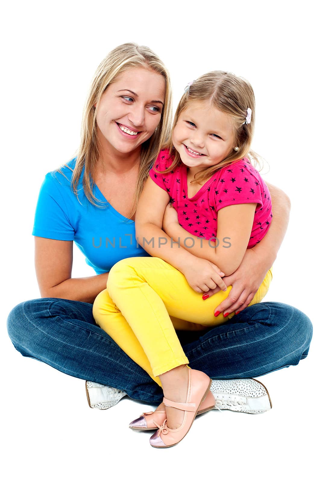 Cute daughter sitting in mother's lap isolated over white