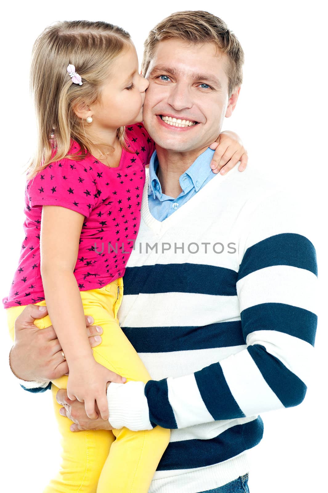 Sweet daughter kissing her smiling father while he holds her in his arms
