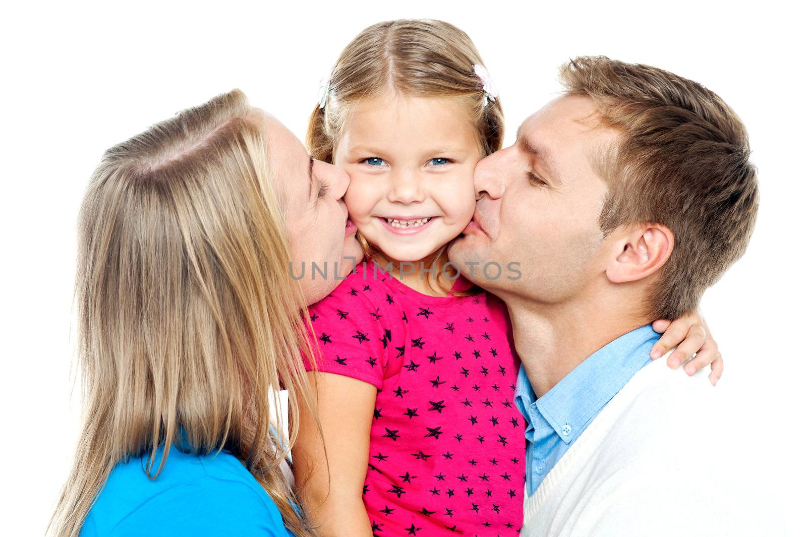 Mom and dad kissing their beautiful kid by stockyimages