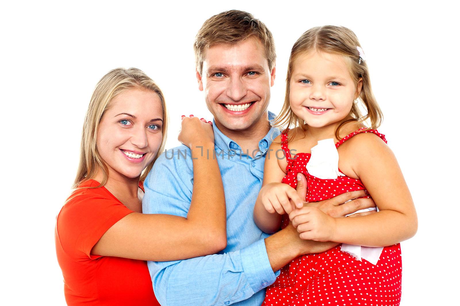 Cheerful family of three facing camera and smiling by stockyimages