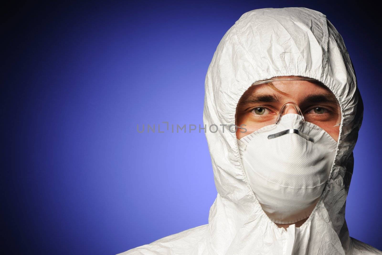 Scientist in protective wear, glasses and respirator 