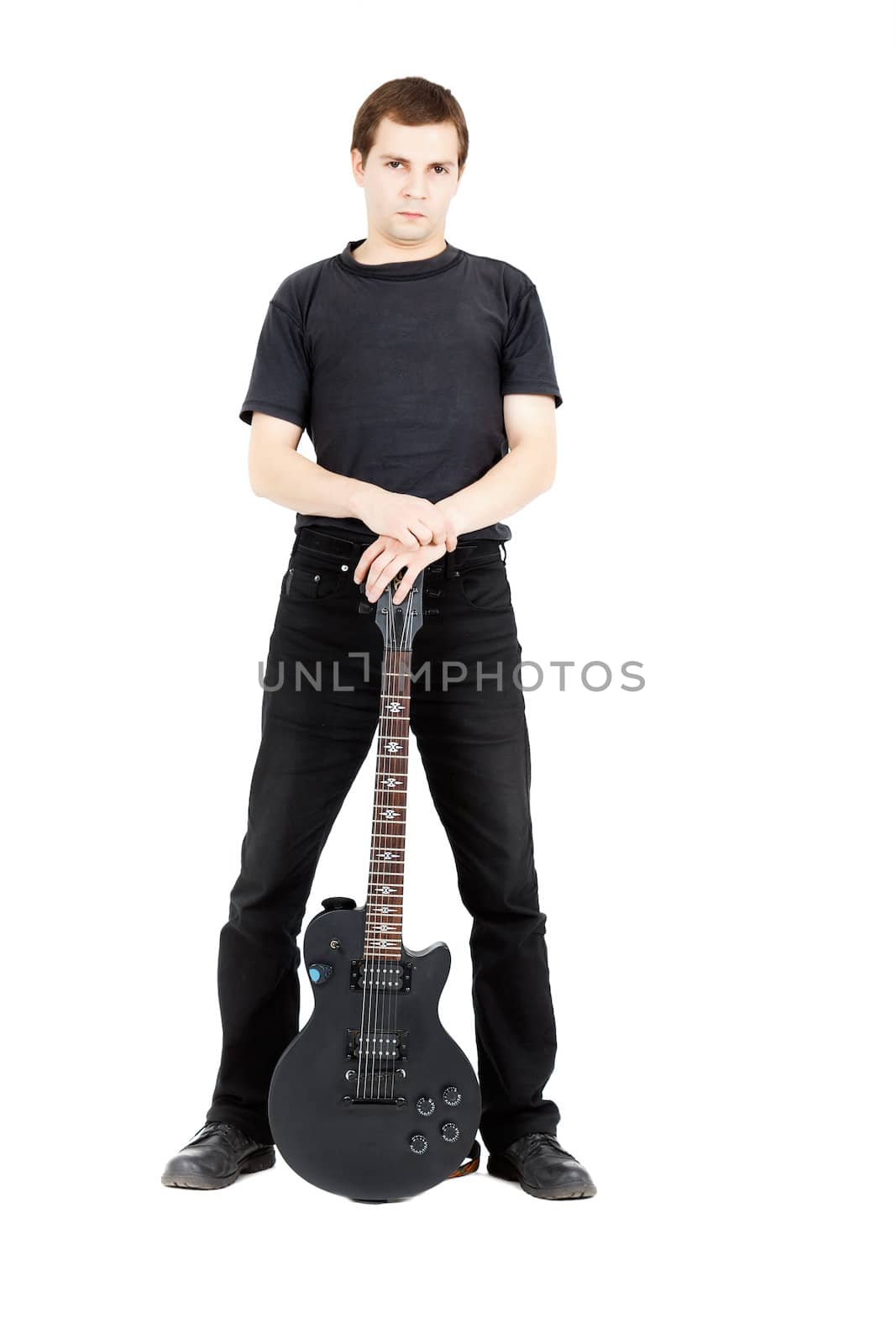 A young man with a black electric guitar isolated on white background