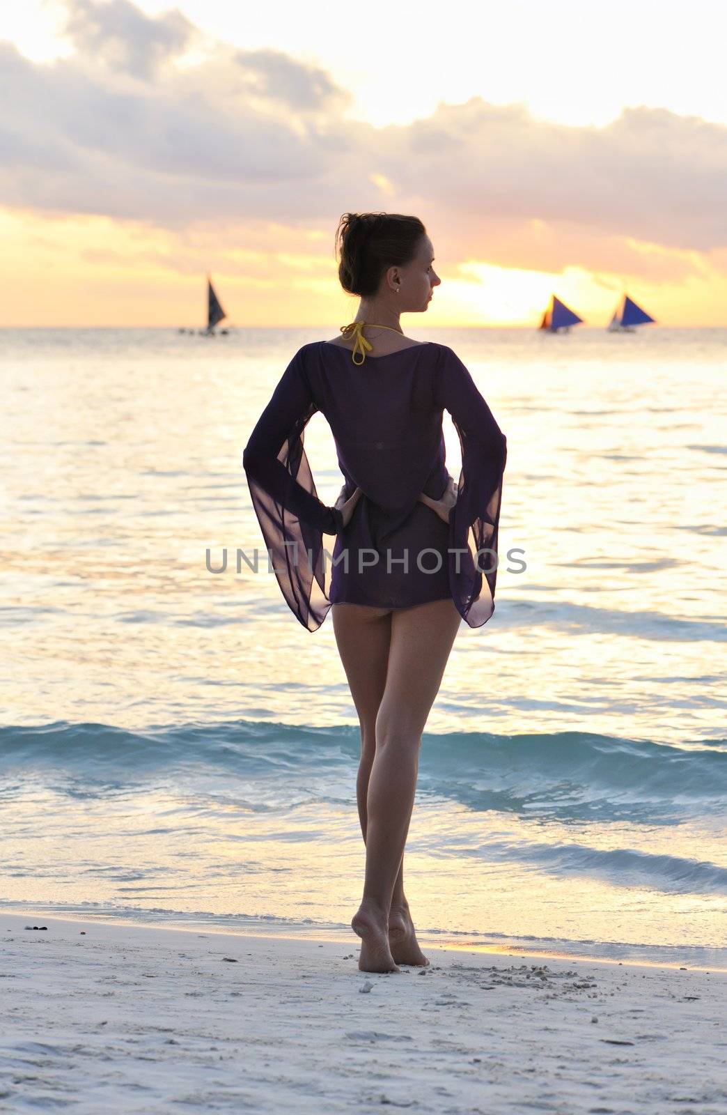 Girl on a beach at sunset 