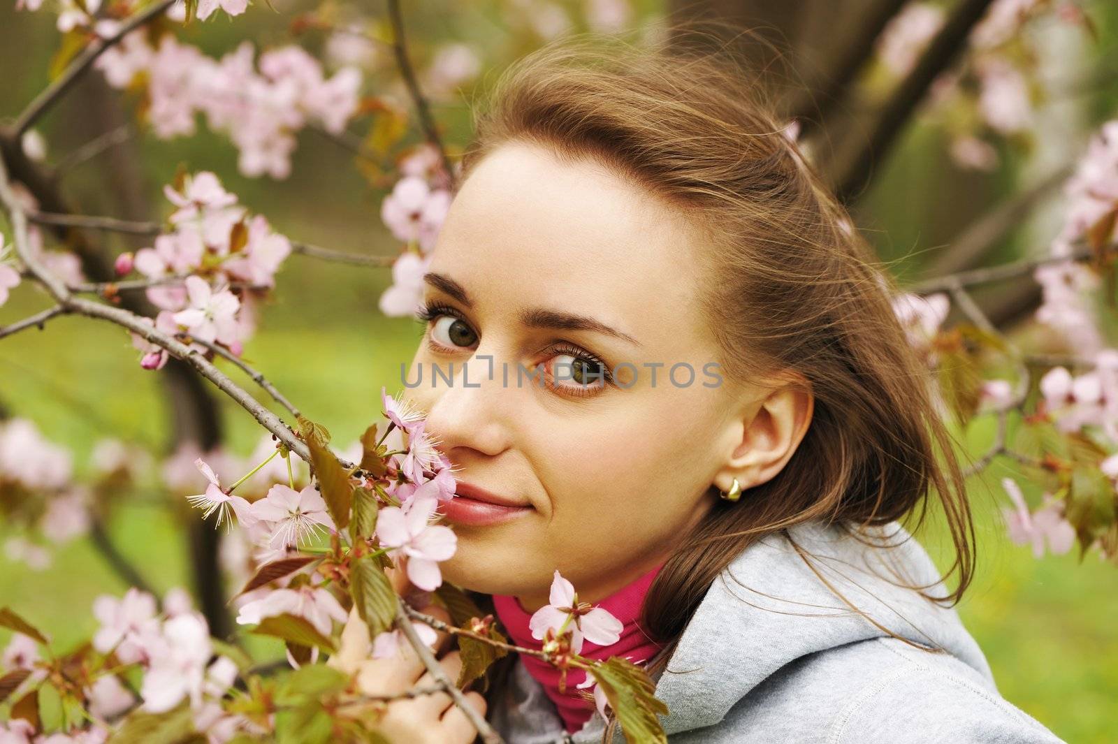 Woman in front of sakura spring blossoms