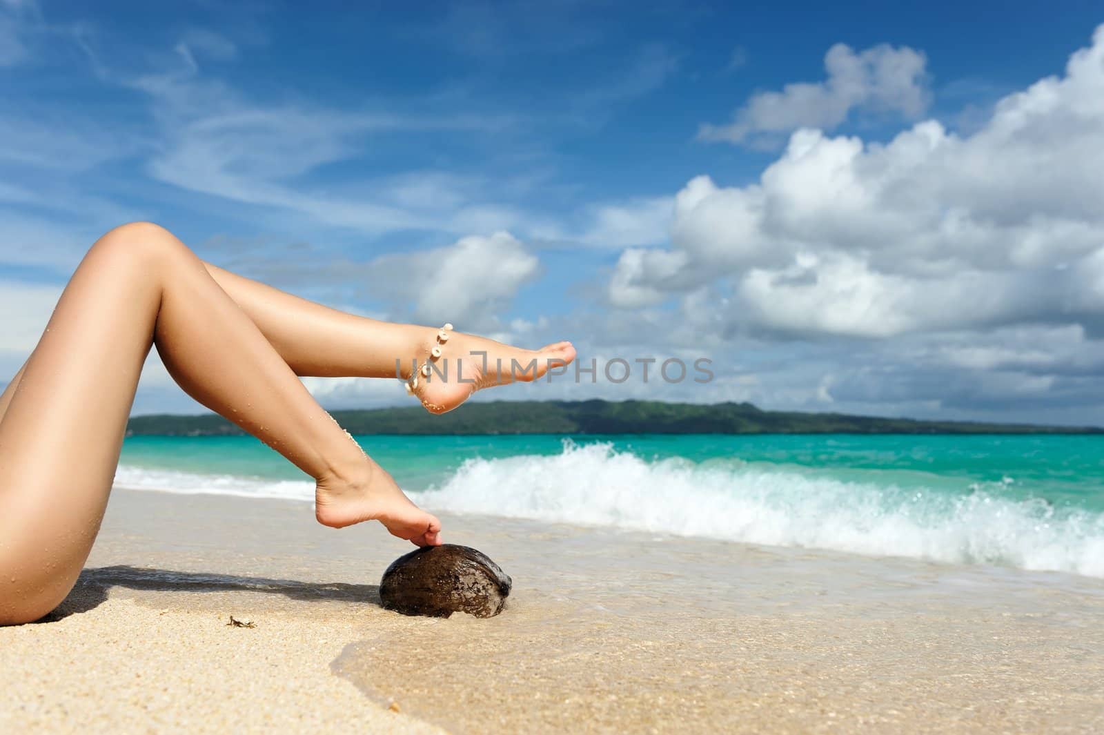 Women's beautiful legs on the beach