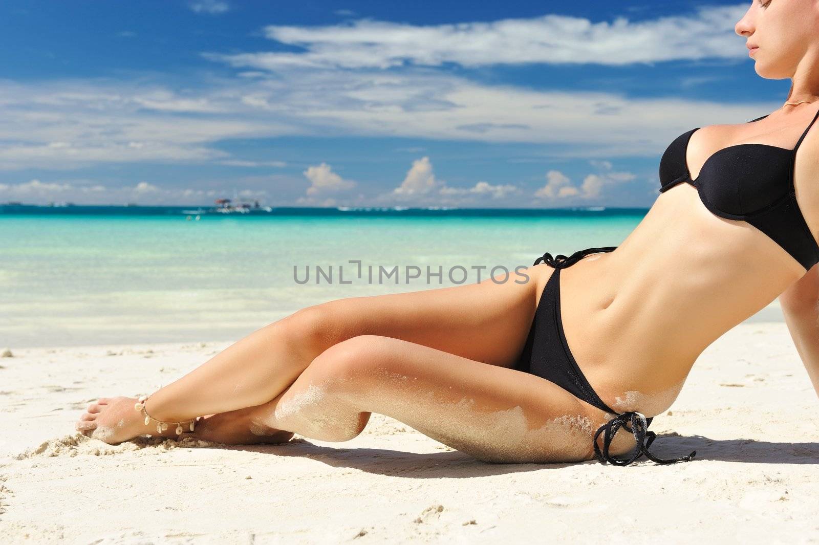 Woman with  beautiful body on a tropical beach