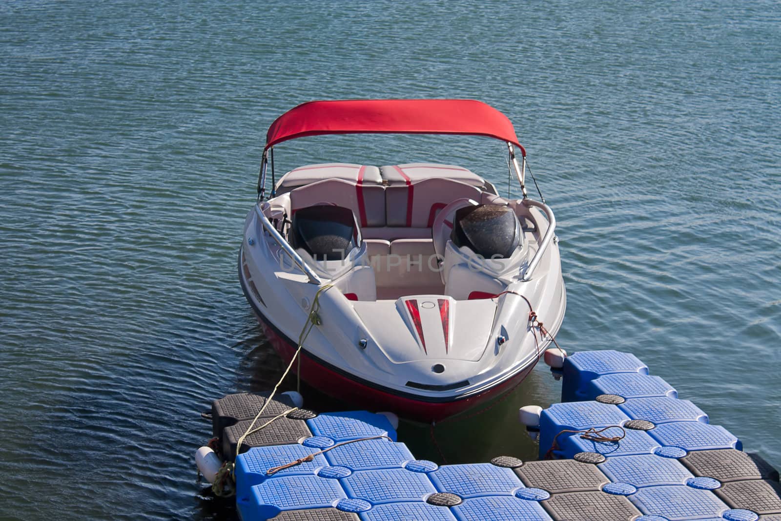 Boat with  motor from  pontoon on  shore against  sea.