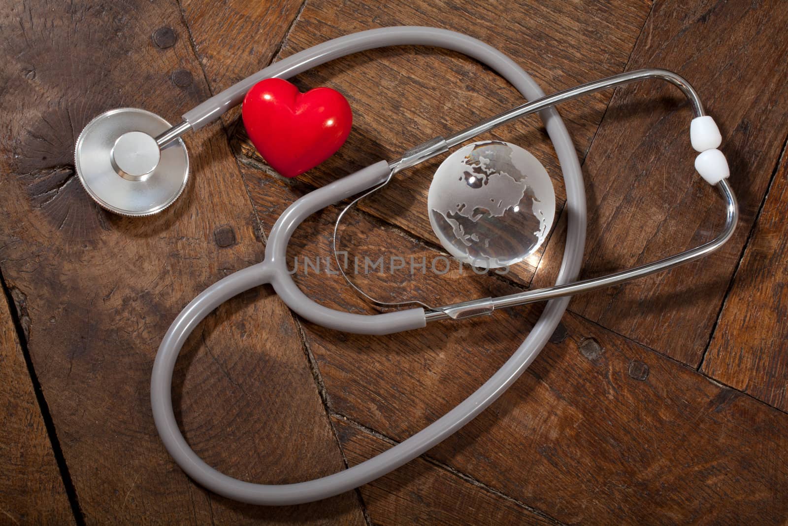 Stethoscope, heart and glass global earth by Portokalis