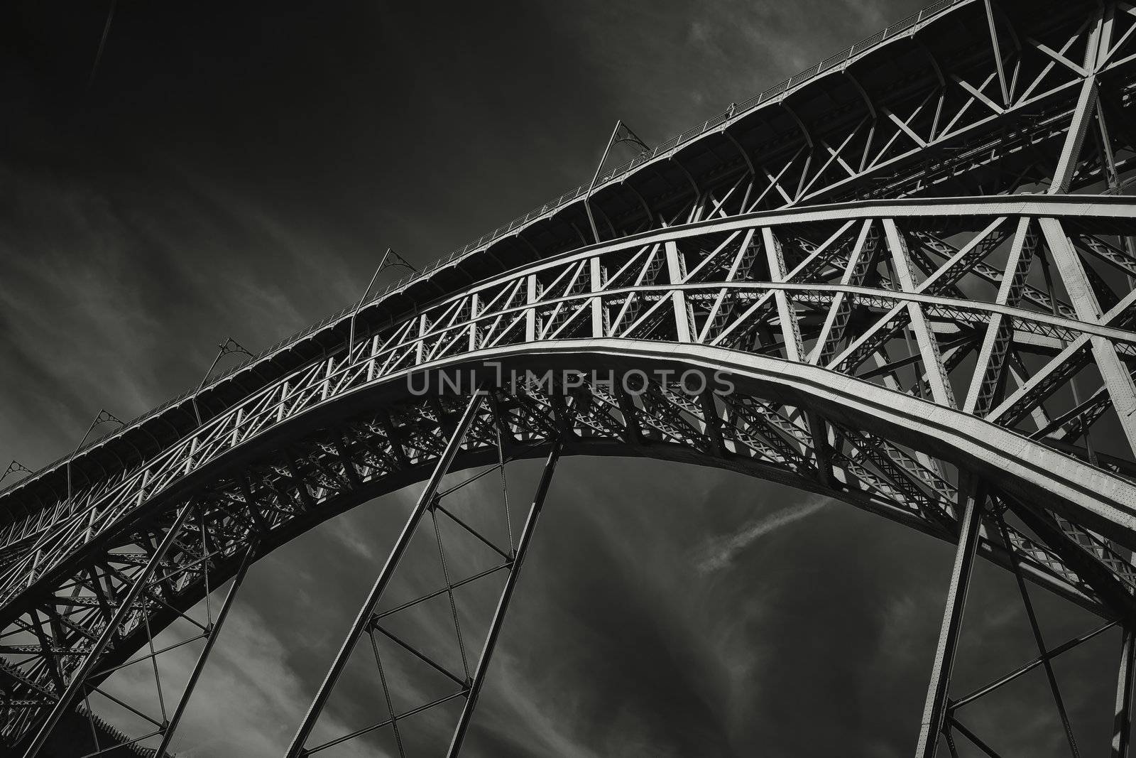 Dramatic monochrome photo of Dom Luis Bridge, Porto - Portugal. The bridge is in two levels and connect the two parts of the city witch the Duoro river divide.