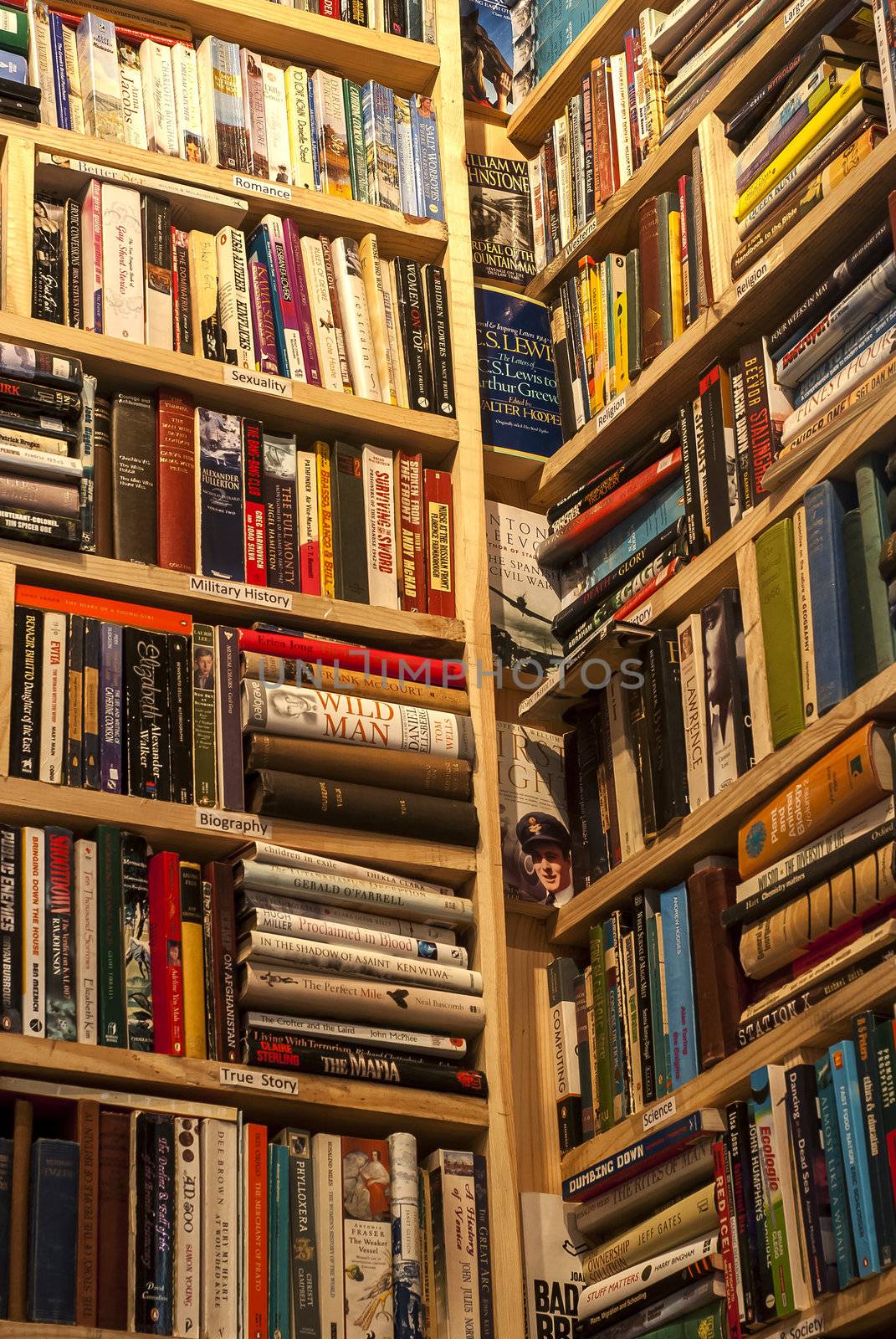 Second-hand bookstore shelves corner vertical symmetric as background