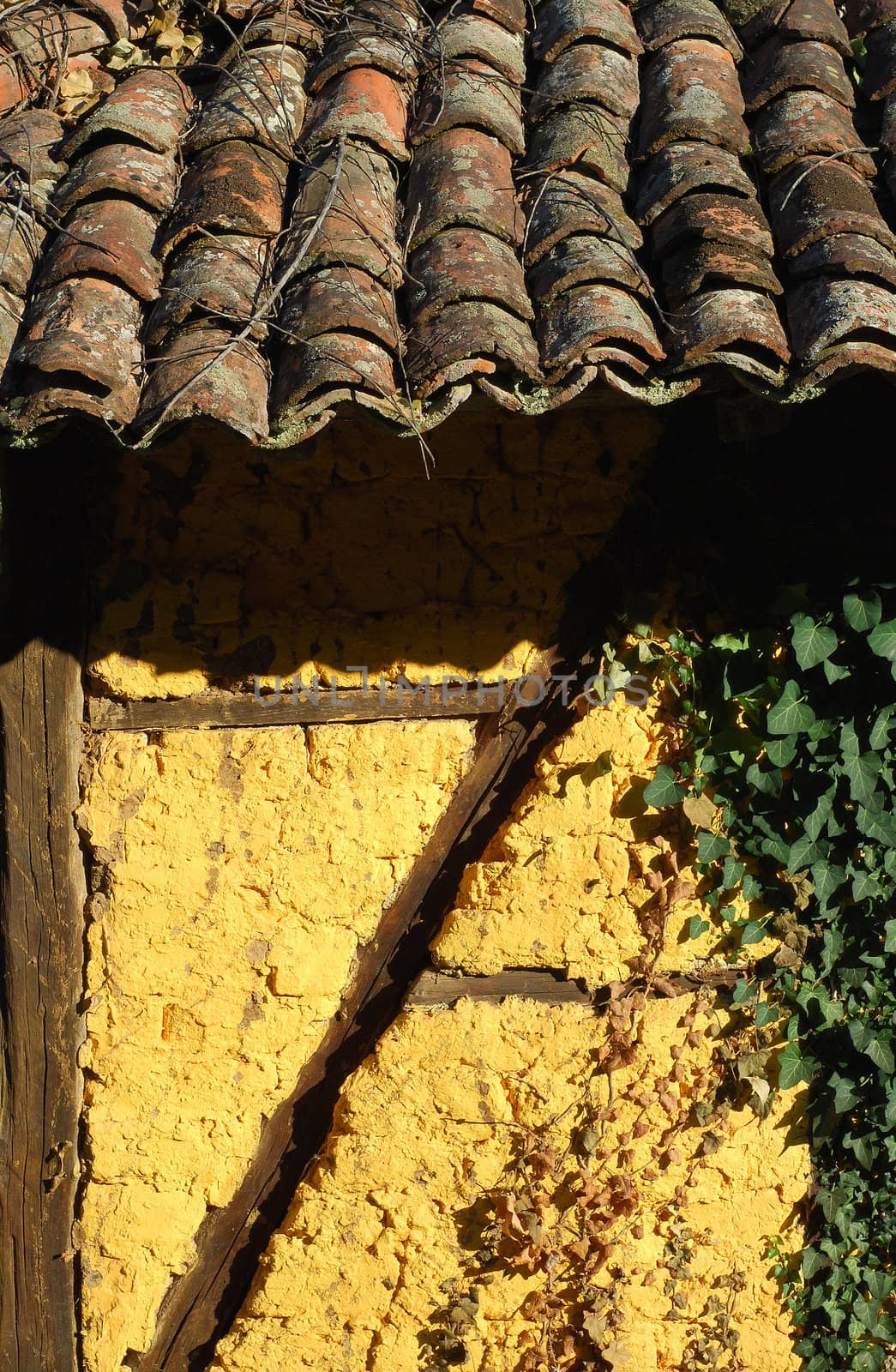 Adobe frame-build yellow wall old roof tiles