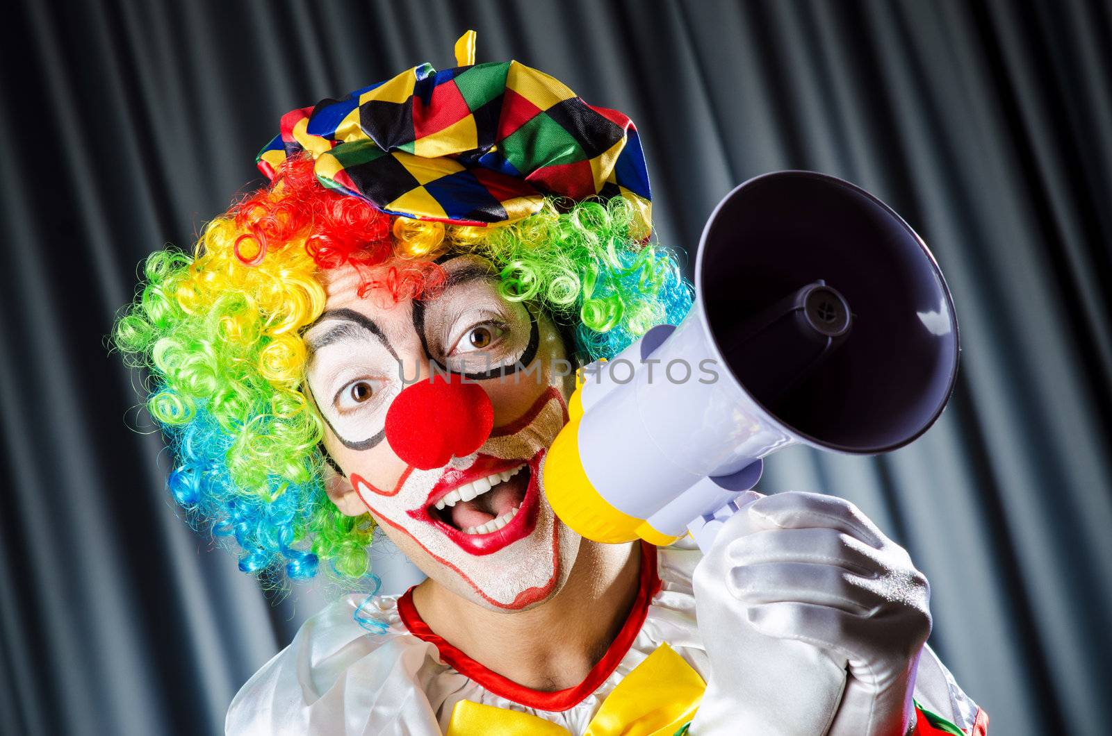 Clown in studio with loudspeaker