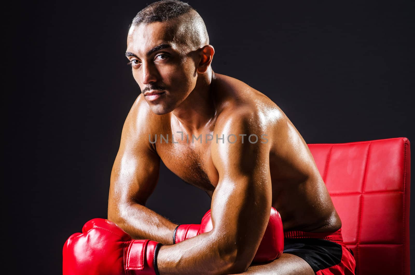 Boxer with red gloves in dark room by Elnur