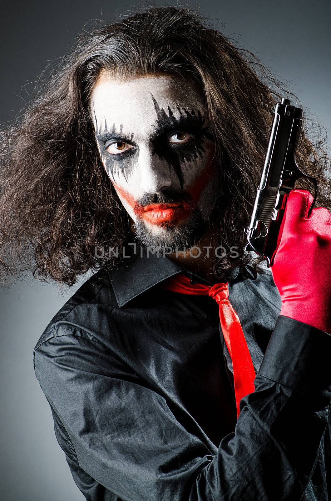 Evil clown with gun in dark room by Elnur