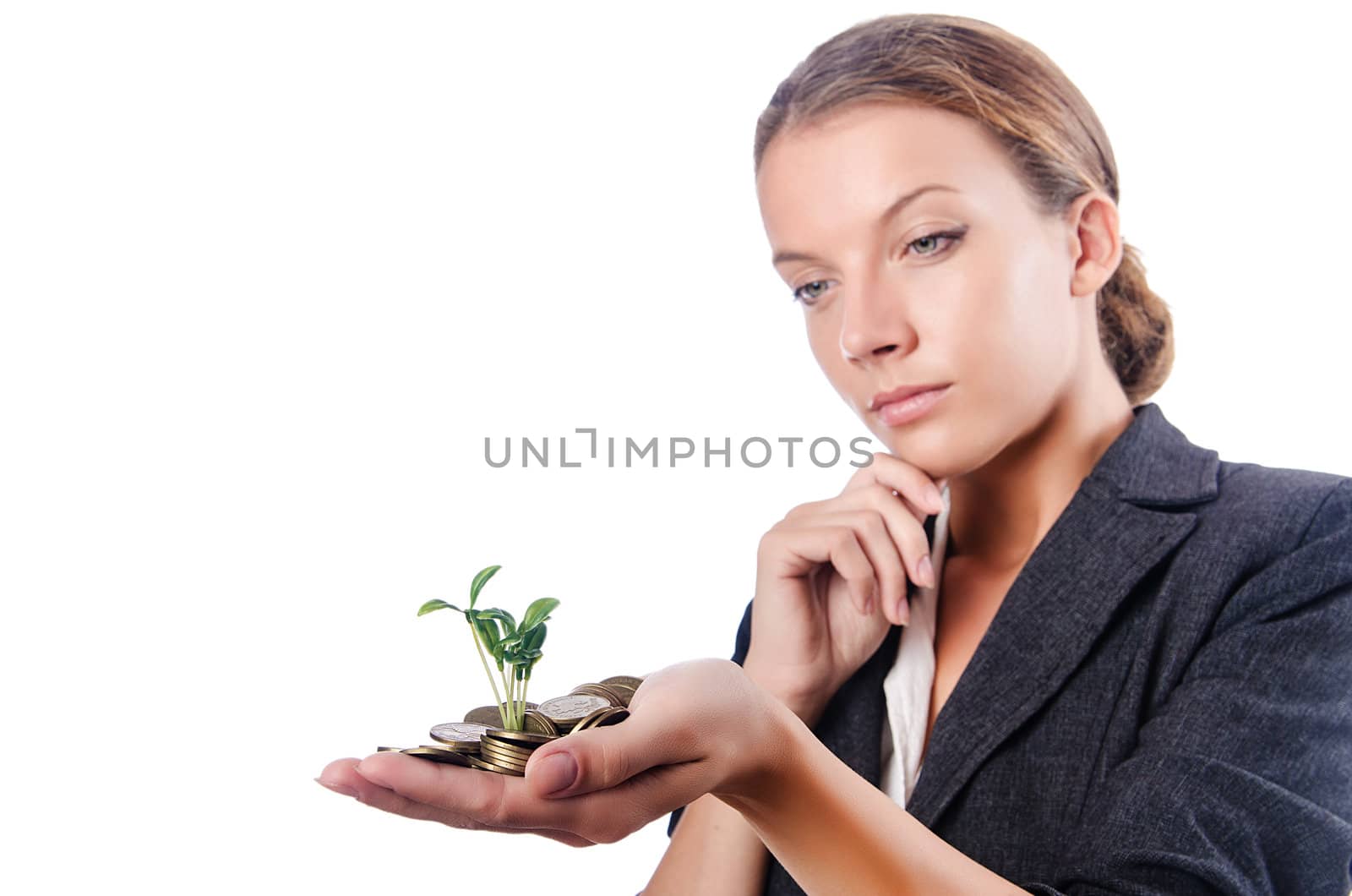 Businesswoman with seedling on white