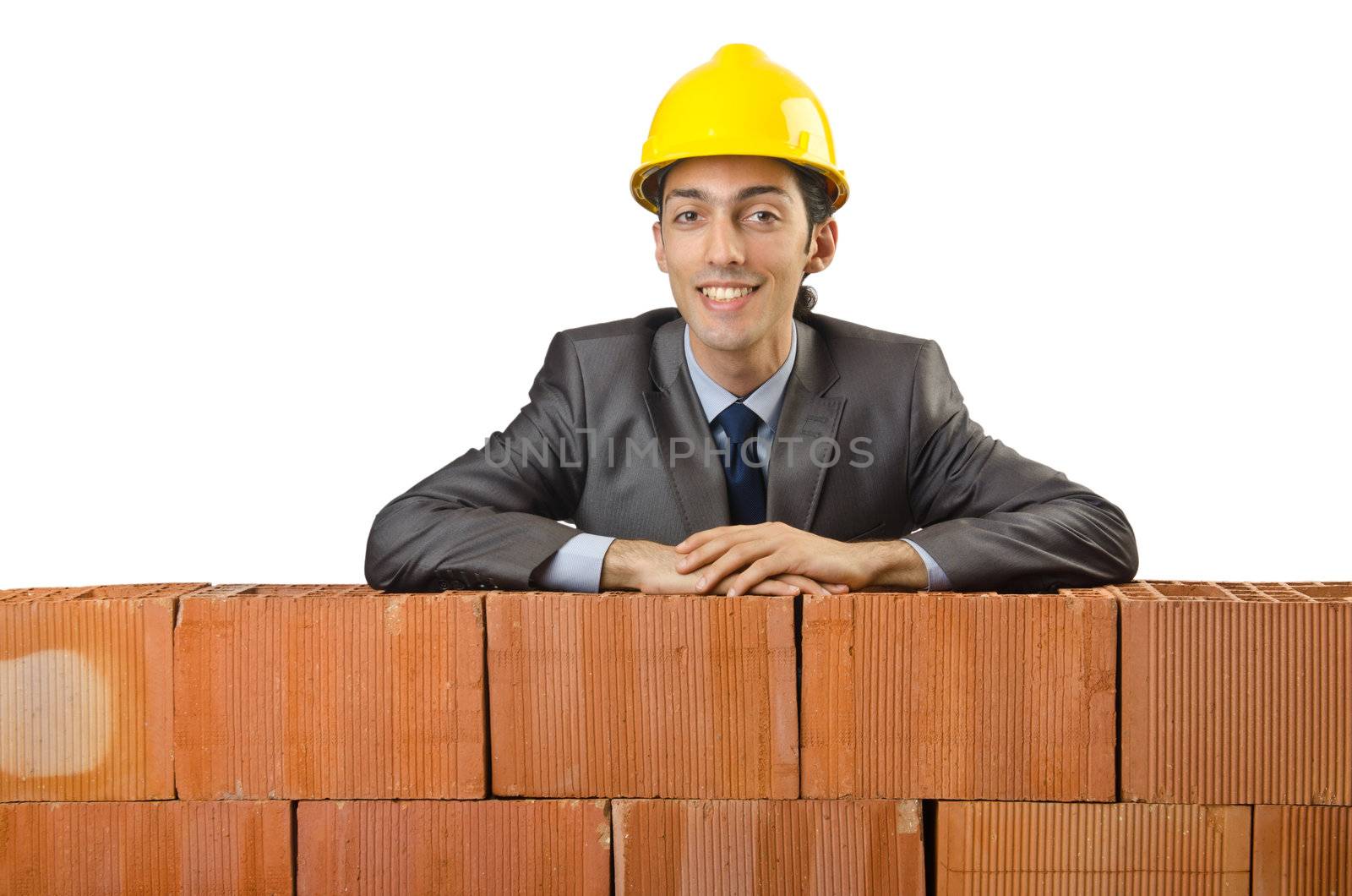 Businessman with bricks on white