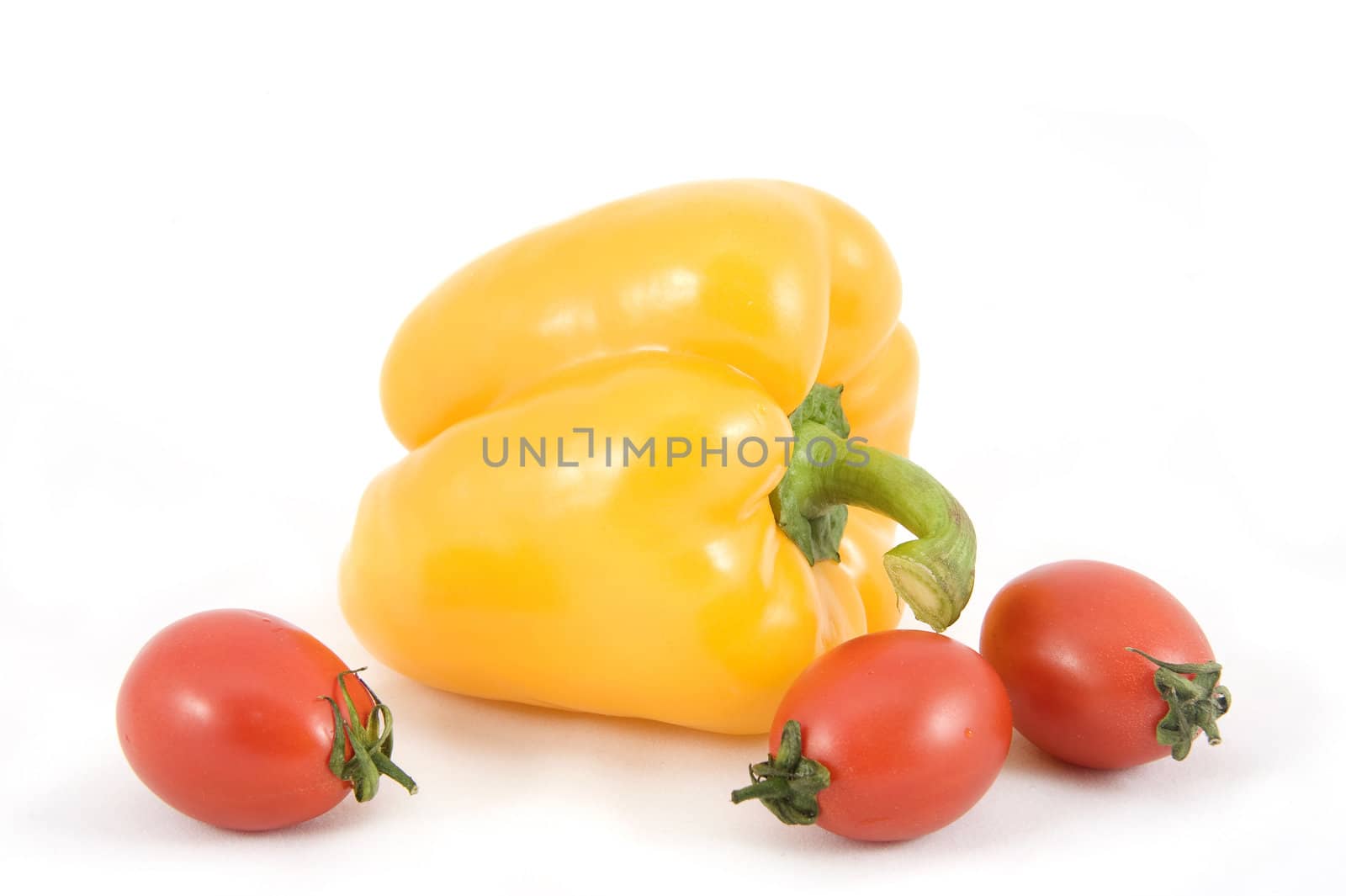 Sweet yellow peppers and tomatoes on white background