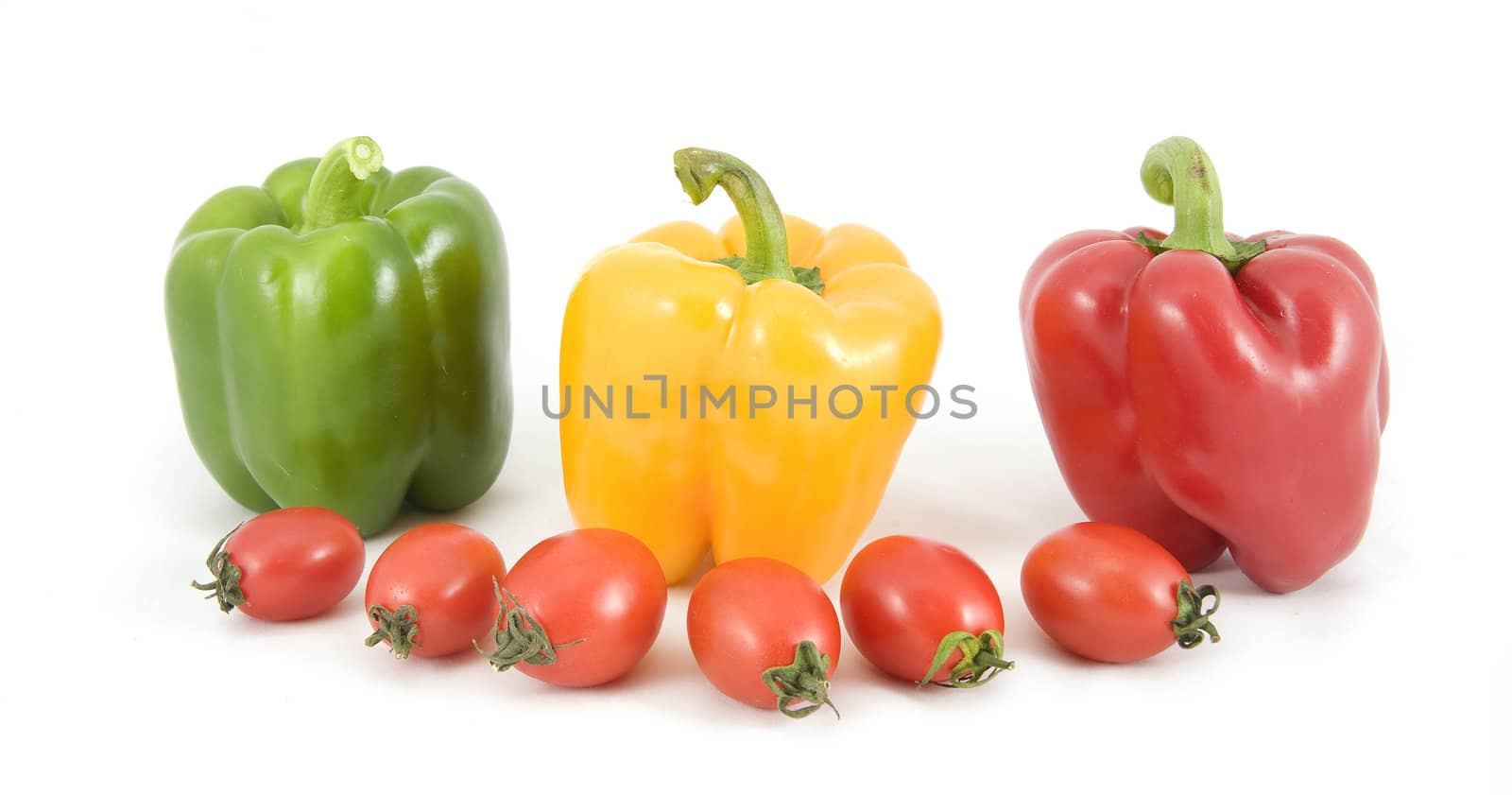 sweet peppers and tomatoes on white background