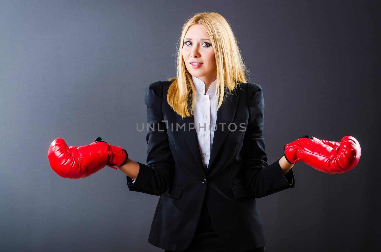 Woman boxer in dark room