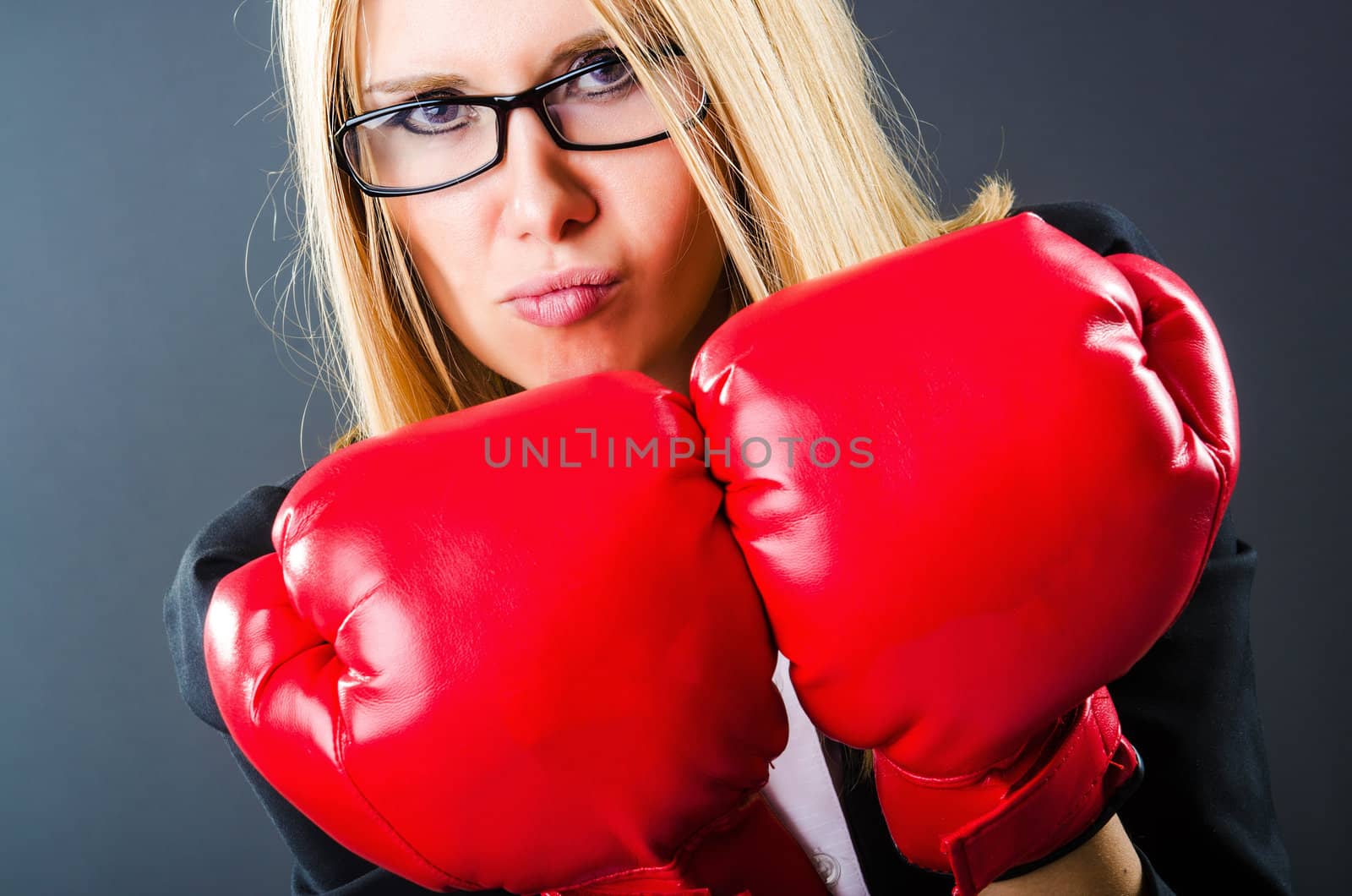 Woman boxer in dark room