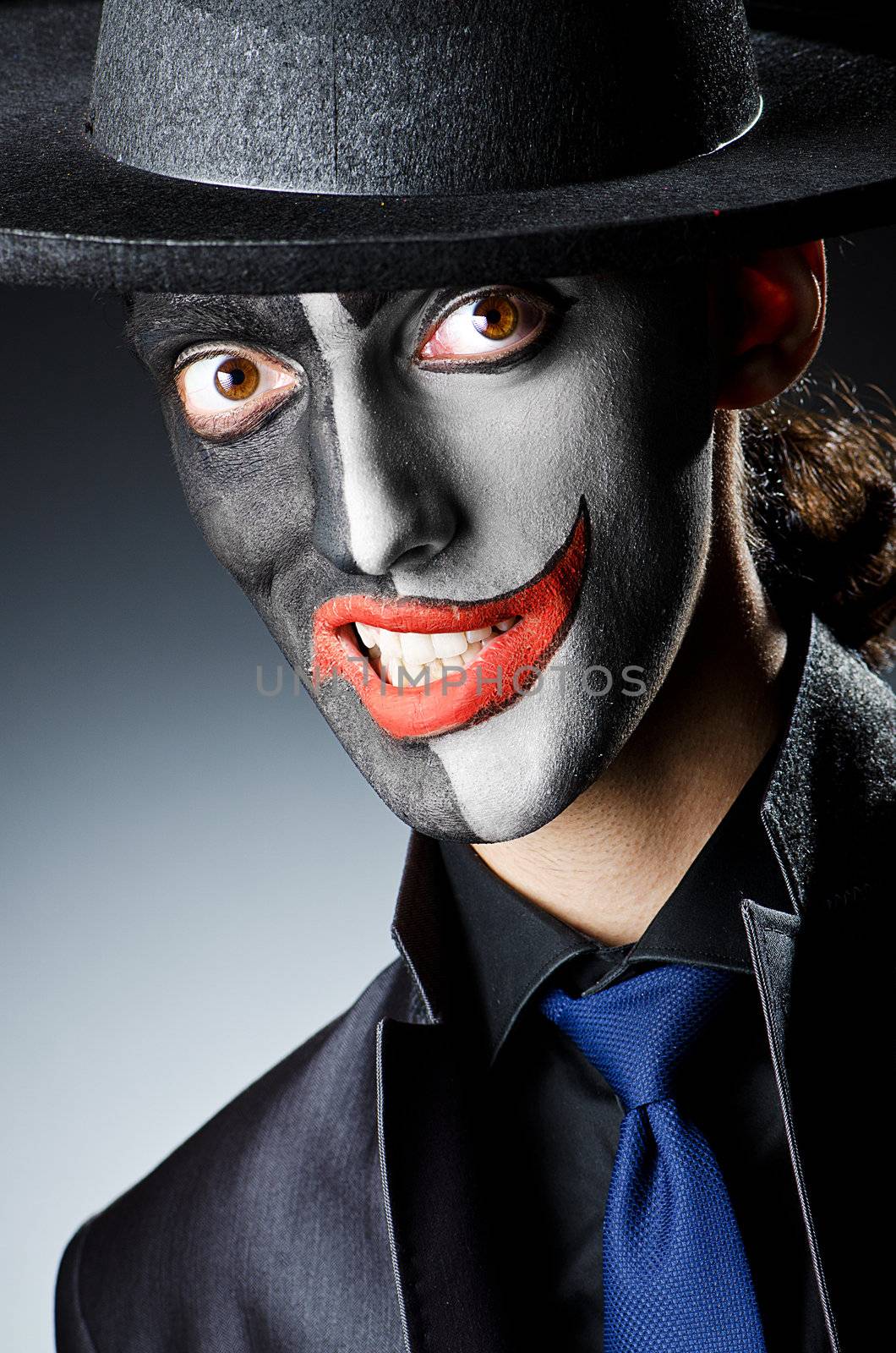 Businessman with clown face paint