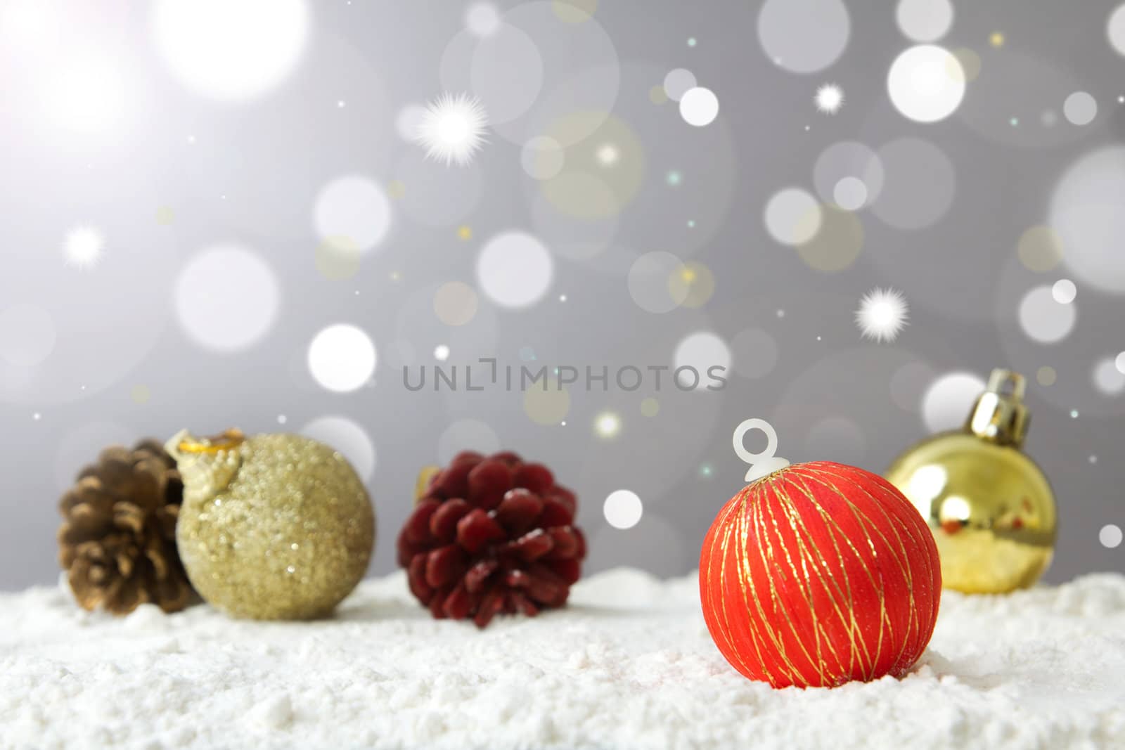 Christmas decoration ball on snow against lights background