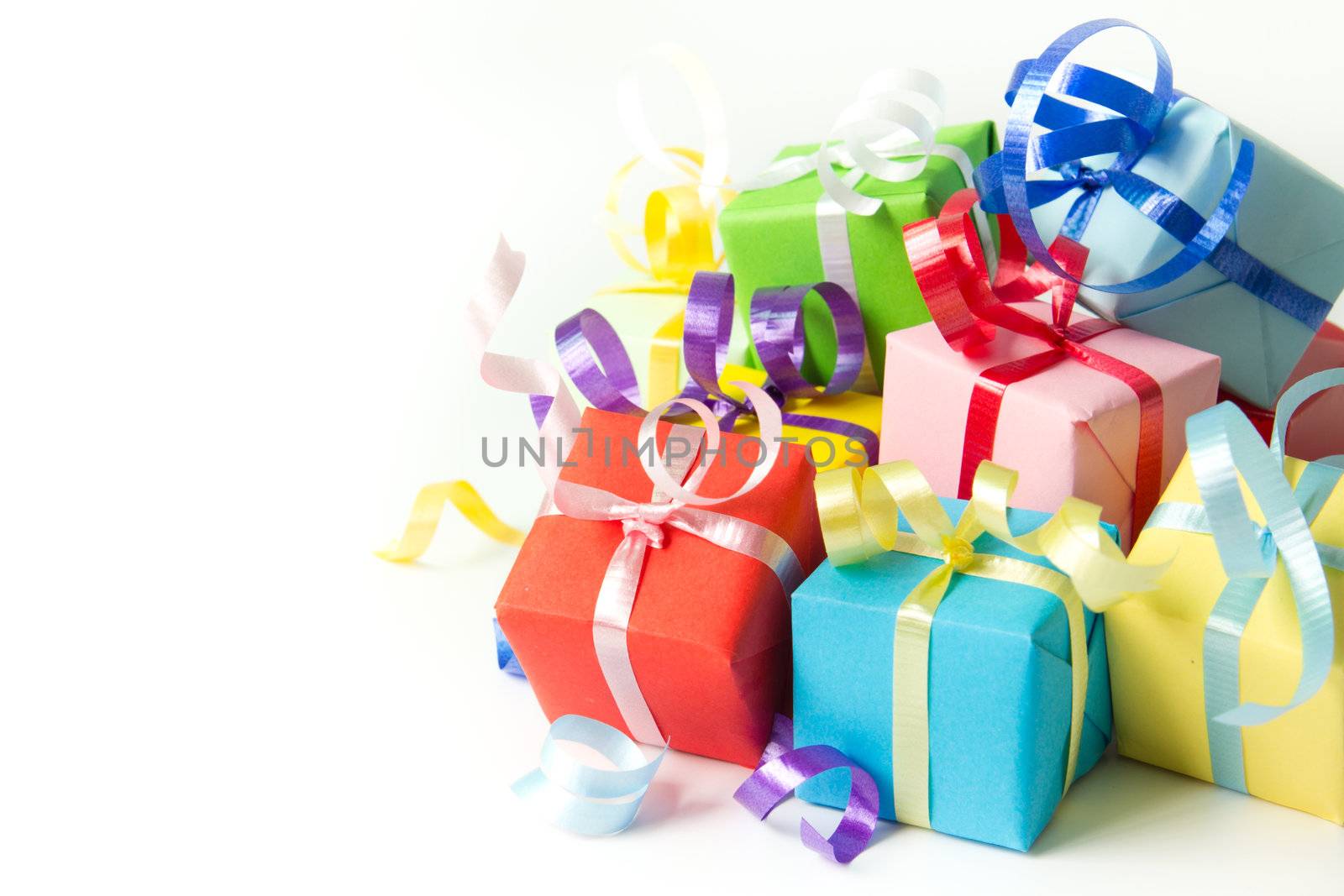 Multi color gift boxes with ribbon isolated on white background