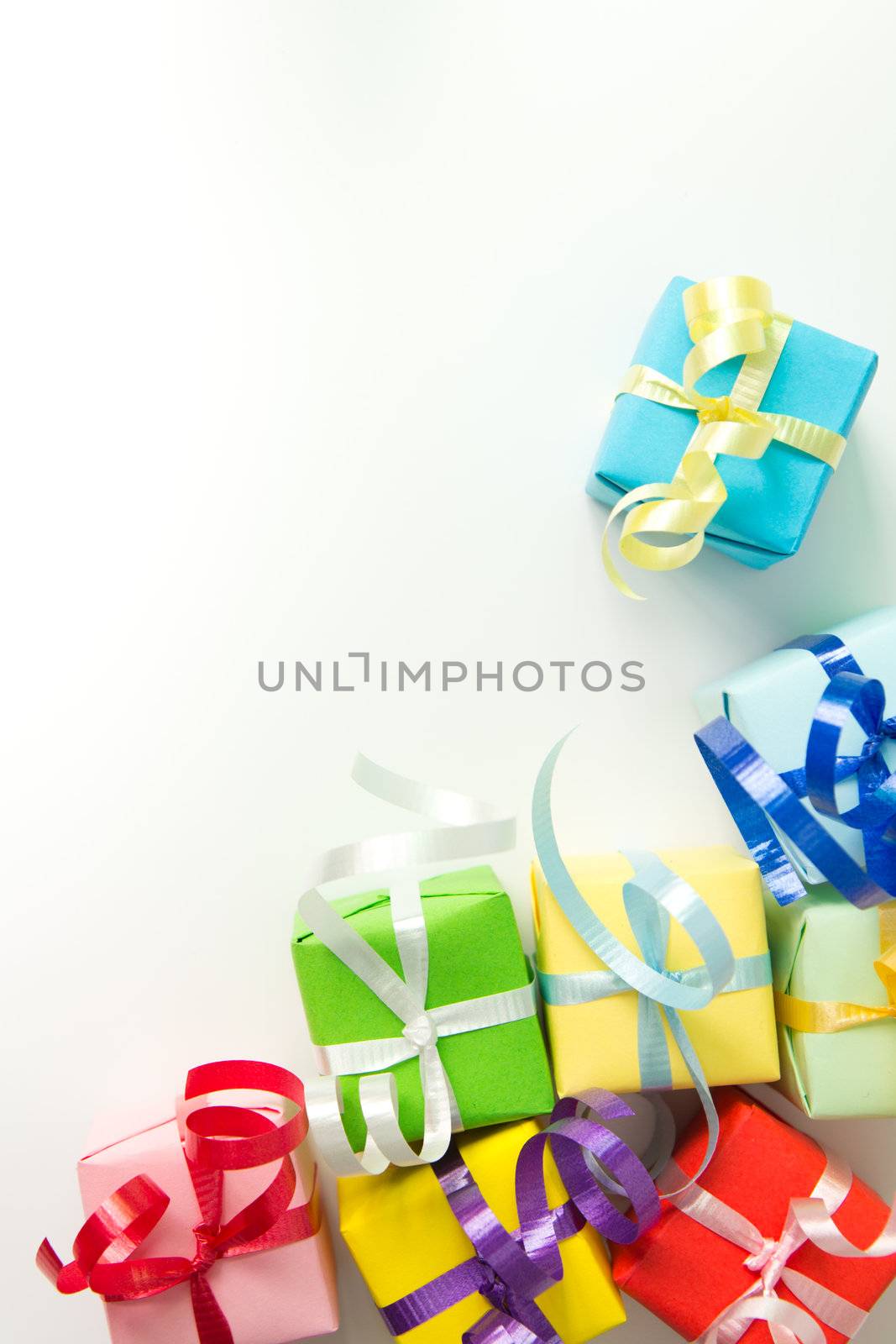 Multi color gift boxes with ribbon isolated on white background
