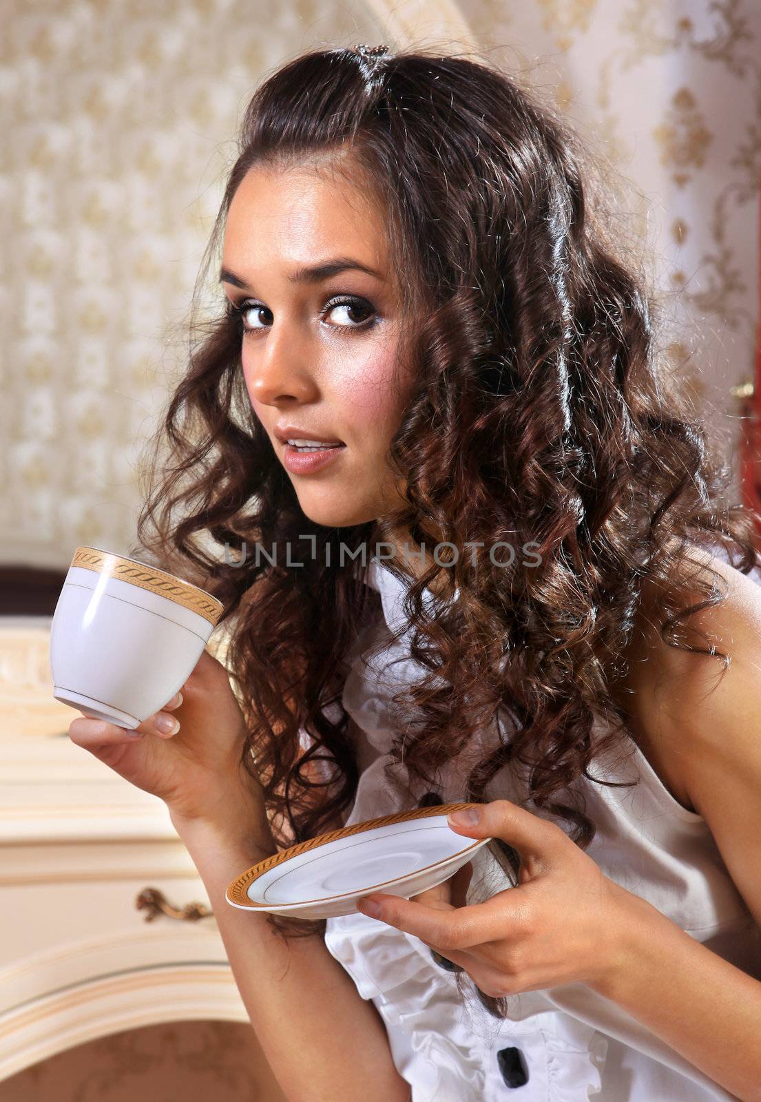 Young woman with white cup of hot drink