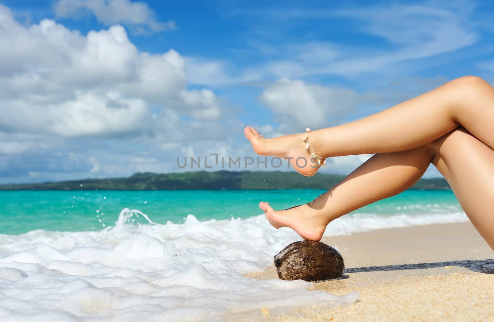 Women's beautiful legs on the beach