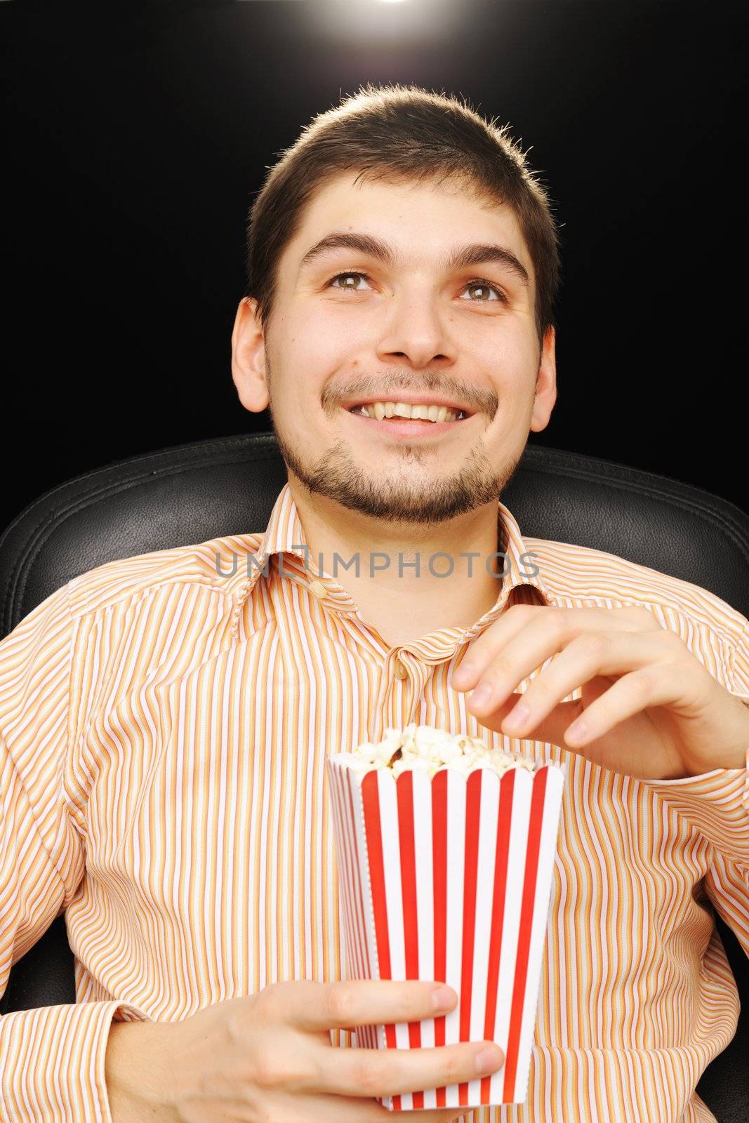 Young man watching movie at cinema