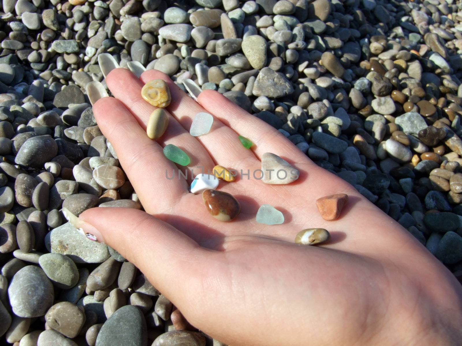 Multi-coloured pebble and glass on a female palm2