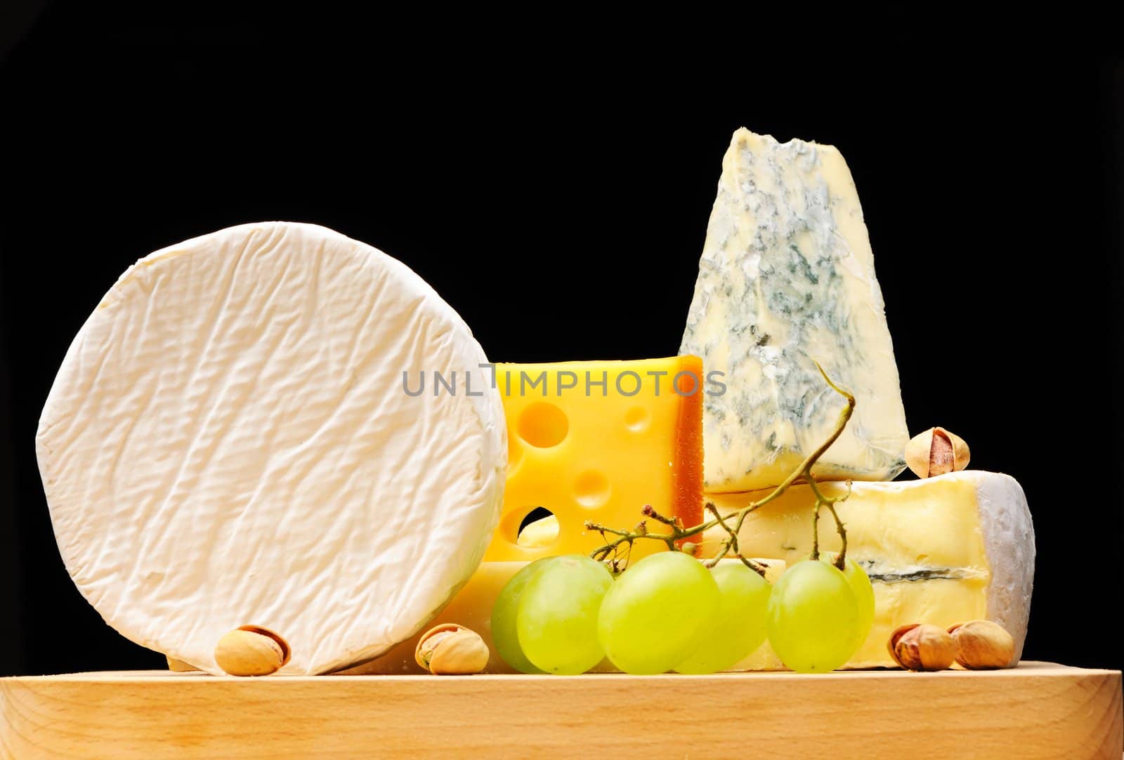 Various types of cheese over black 