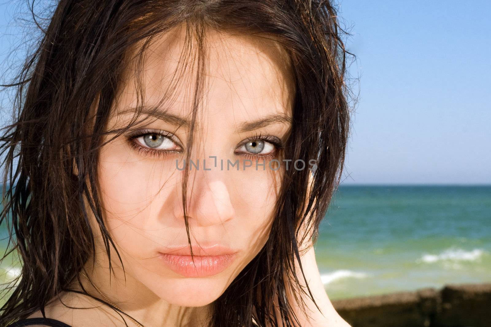 Portrait of the attractive young woman on a beach