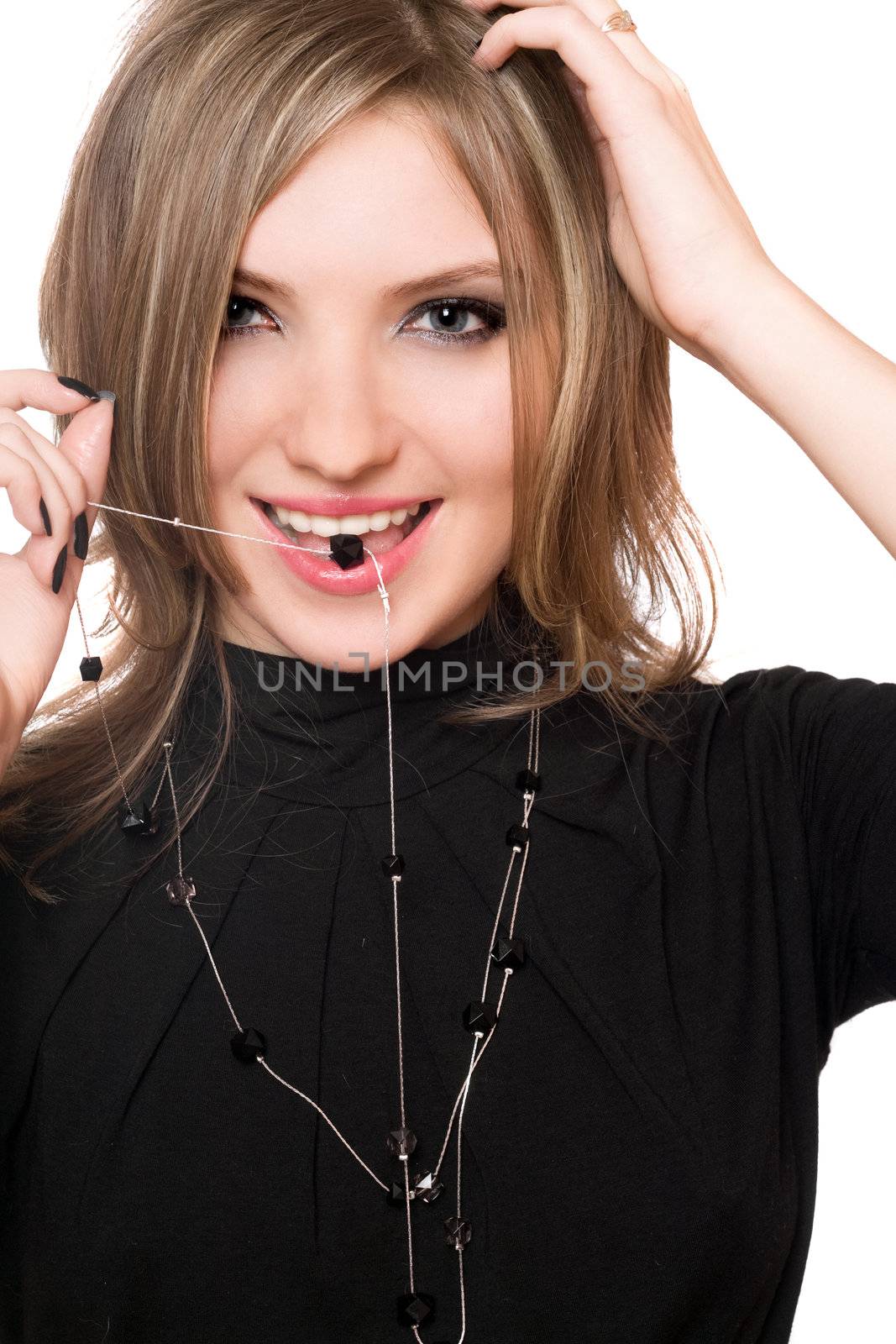 Portrait of smiling girl with a bead in her mouth. Isolated